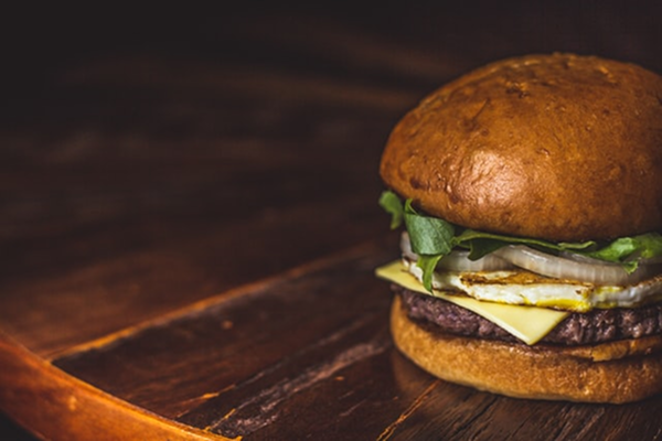 Header banner of cheeseburger on the brown background.